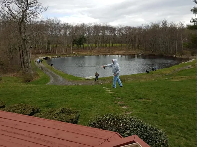 People Walking by Pond