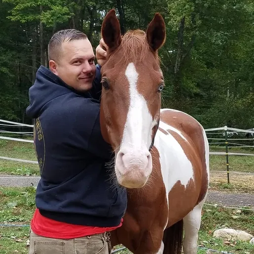 Man Hugging Horse